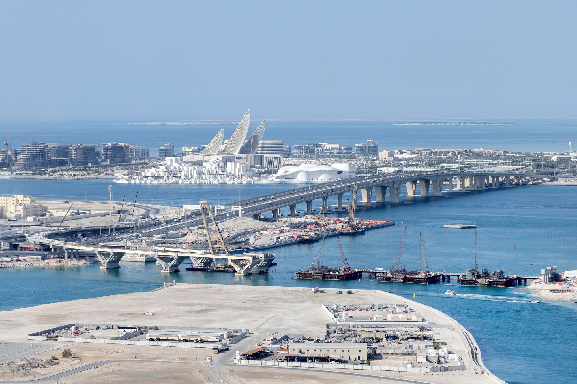 Infrastructure construction across the water in Abu Dhabi, with the Zayed National Museum beyond